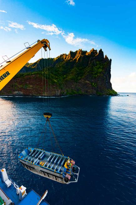 The Aranui 5 pontoon for whale watching is launched by crane off Fatuiva
