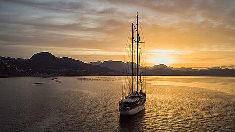 Sailing yacht SV Chronos at sunset in the Caribbean Sea