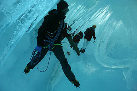 Kletterer in einer Eishöhle bei Antarktis Segelschiff Expedition