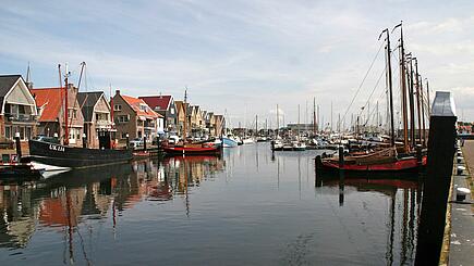 Houses and Sailboats in historic village Urk, Netherlands, by the water