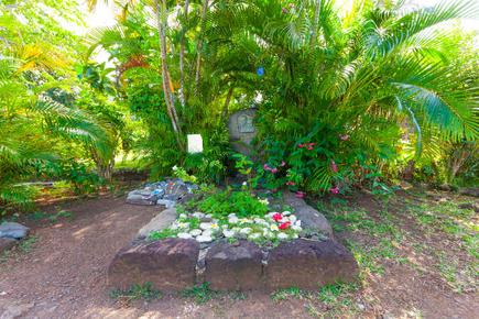 Jacques Brel's grave surrounded by flowers at Calvary Cemetery, Hiva Oa, French Polynesia, a popular tourist destination
