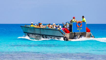 The Aranui 5 pontoon with passengers whale watching at Rangiroa Atoll, French Polynesia