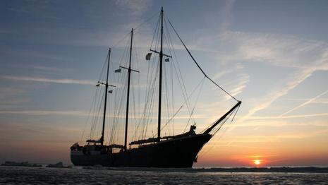 Sunset sailing trip on three mast sailing ship